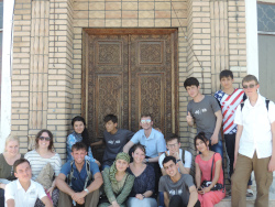 Photo of our staff and volunteers sitted outside of an old building